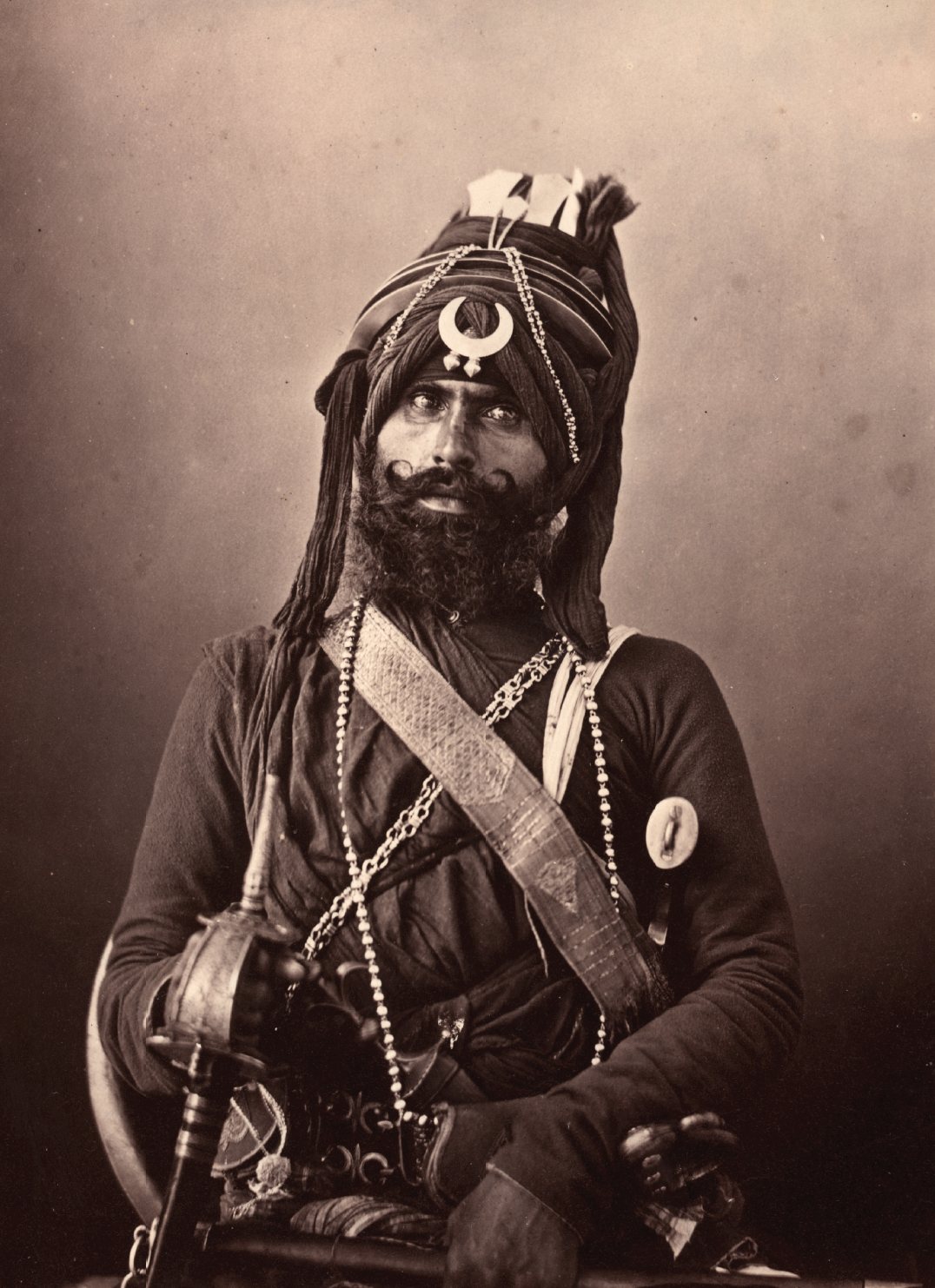 19th-century photograph of an Akali-Nihang warrior wearing a towering turban with steel quoits