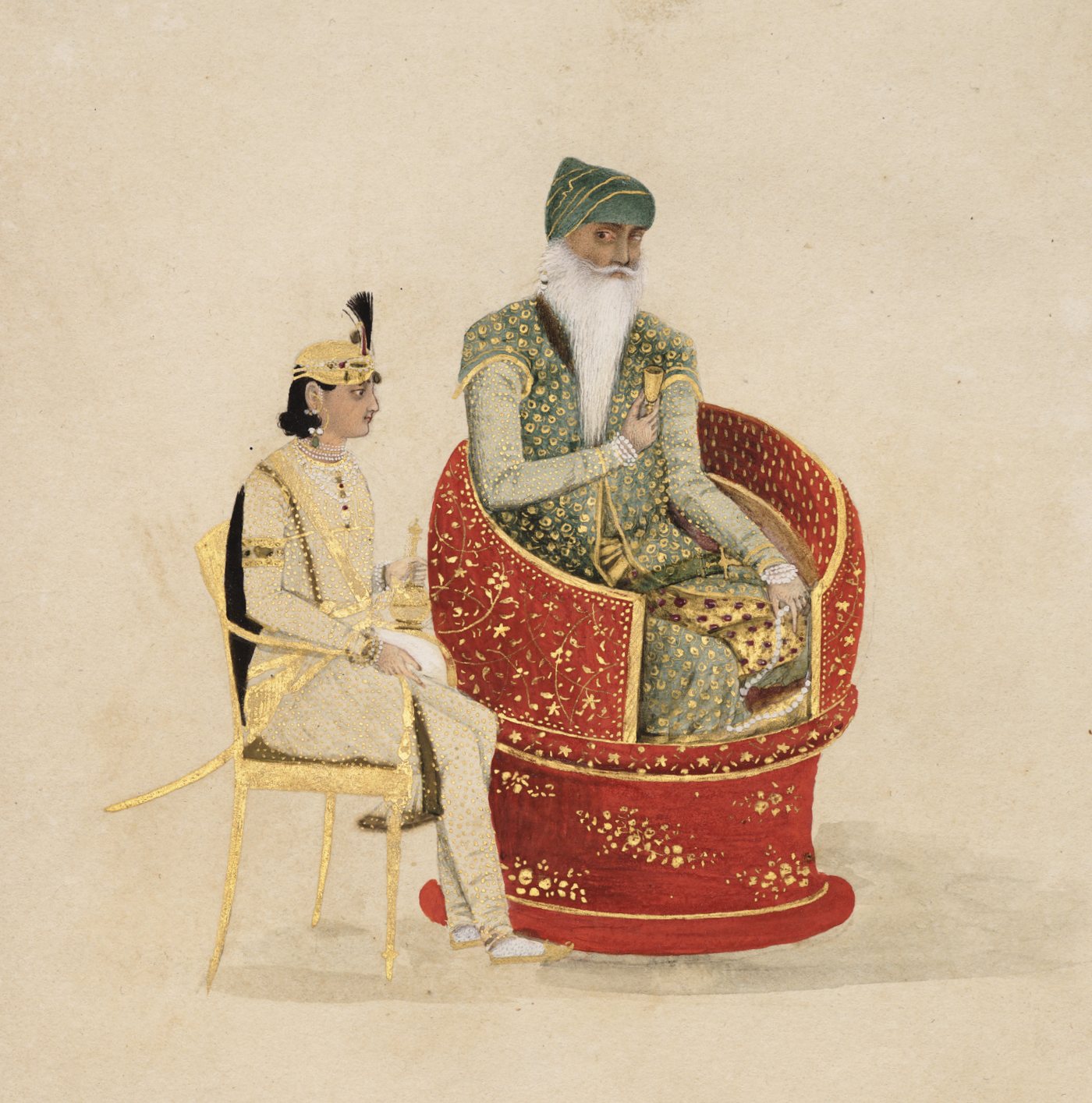 Maharaja Ranjit Singh seated in an ornate red and gold chair, with a young attendant beside him
